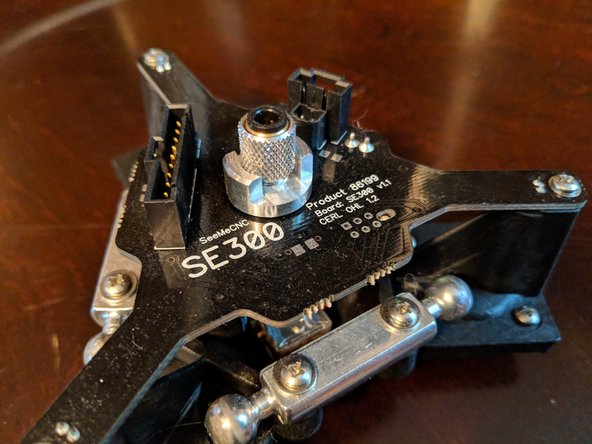 Loosen the collar below the knurled thumb screw that holds the PTFE tube on. See Figure 1 and Figure 2.