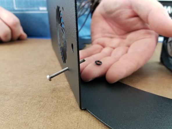 This fan is used as an exhaust and the arrow should face the sheet metal.