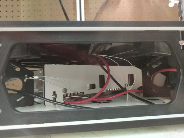 The rib features on the insulator will straddle the boss features of the bed clamps (attached to the base top plate.