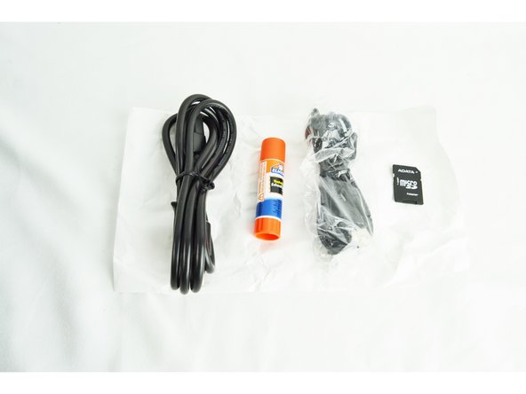 Attached to the glass plate was a bag of accessroies. They are shown here. Each printer comes with a power cable, USB cable, glue stick (for prepping glass plate) and SD card.