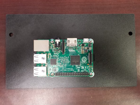 Using the (4) provided standoffs and (4) #4 screws, attach the Raspberry Pi to the side panel.  The Micro USB connector should be facing up and the USB and ethernet connectors should be facing to the left of the side panel.  Be sure not to over-tighten the screws!