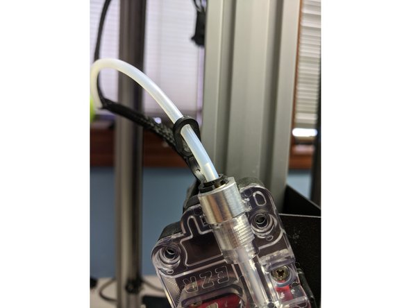 To use the load filament macro, hold in the red button on the EZR extruder and press the filament in until it is just peeking out the side with the boden tube. Then click &quot;Filament Load&quot; under User-Defined Macros, and click OK.