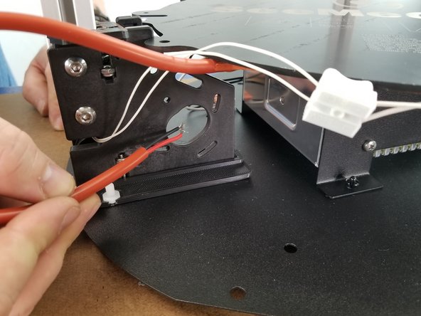 Strip approximately a half inch of the wires in the orange tube coming from the heated bed.