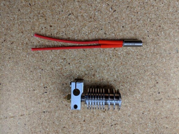 Screw the heat break and heatsink into the heater block watching the threads of the heat break until the end of the threads are just about even with the the heater block.