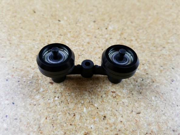 The spring arms consist of an inner and outer halves that retain two of the R4 bearing rollers you assembled in Step #2.