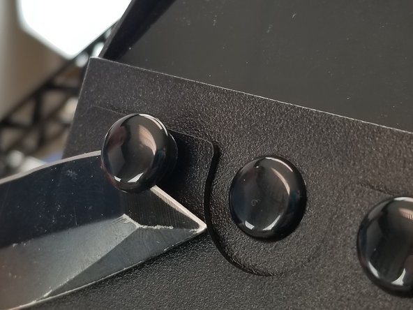 CAREFULLY use a thin object like a screwdriver or pocket knife to pop out all four plastic push rivets that are holding the extruder plate in place.