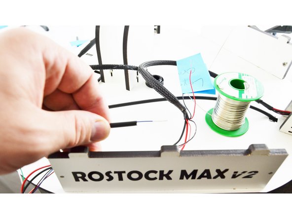 Slide a piece of 15mm long heat-shrink tubing over the blue wire.