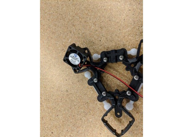 Insert one layer fan with the fan label facing away from the ball arm, as shown.