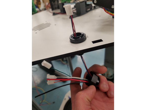 Now push the 4pin connector through the top half of the Cable Mount Hub still attached to the Laser cut Panel.