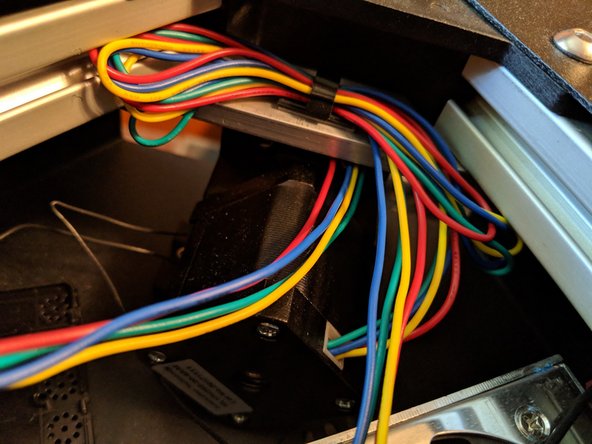 With all 4 motor wires fed through, pull them all the way through into the top of the machine as seen in Figure 2.