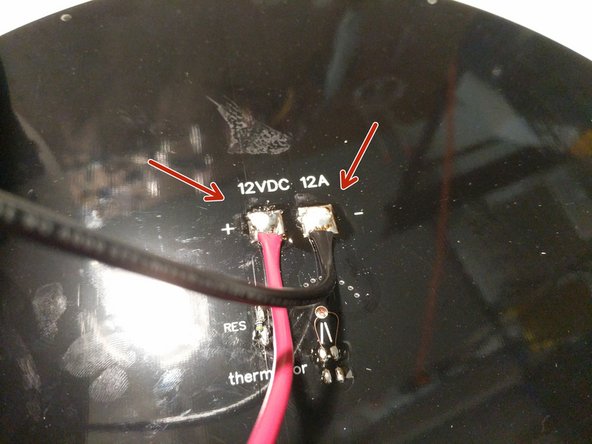 Move the heated bed close enough to the printer that the wires will reach the pads that you have tinned.