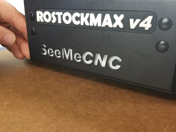 Line the white acrylic up behind the logo and press the double sided tape into the sheet metal to secure it in place.