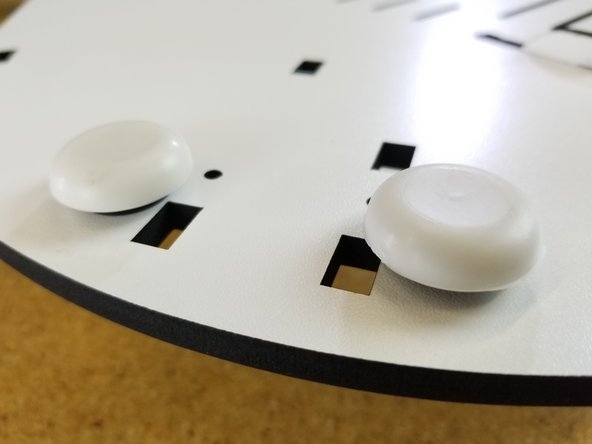 Install the included rubber bumpers on the feet.