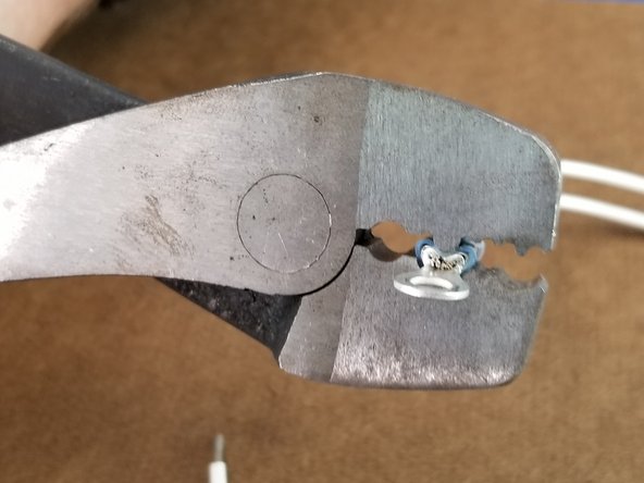 Place the blue ring terminal over the pair of wires and crimp as before securing the two wires in the blue ring terminal.