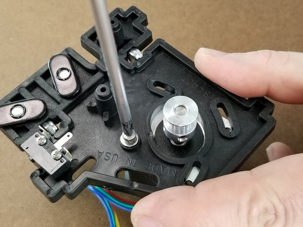 Using the M3x10mm screw with washer, attach the motor to the bracket using a standard P1 Phillips screwdriver.