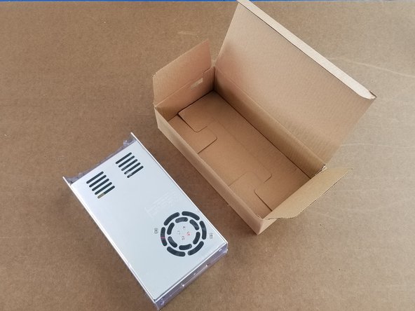 Open the box containing the power supply.