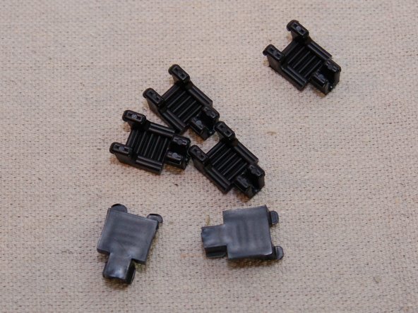 Begin by routing the belt through the top side of the carriage as shown in the first image.