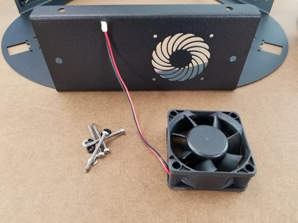 This step will use the lower sheet metal, the 60mm x 60mm x 25mm fan from the electronics pack, 4x M3 x 35mm long phillips screws from the lower hardware pack, and 4 o-rings from the lower hardware pack.  You will also need 4x M3 nylon lock nuts and 4 washers.