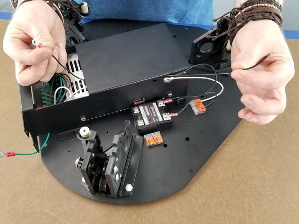 Feed the ring terminal into the power supply bracket hole and feed it to the front of the power supply as shown in Pic 2.