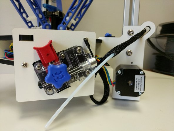 Secure the whip to the bottom base plate using a zip tie in the location specified in the image.  Also secure the whip to the edge support standoff as indicated.