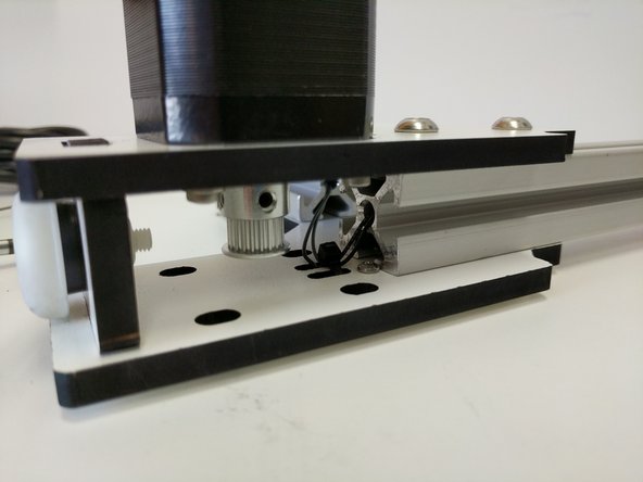 Secure the end-stop wire to the non-motor mount base laser cut piece using a zip-tie.