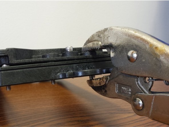 Using a pair of vise-grip pliers, c-clamp, or an extra set of hands, apply pressure near the middle of one of the short edges of the assembly (be sure not to cover up the counter-bore for the 6-32 x 5/8&quot; Socket Head Cap Screw)