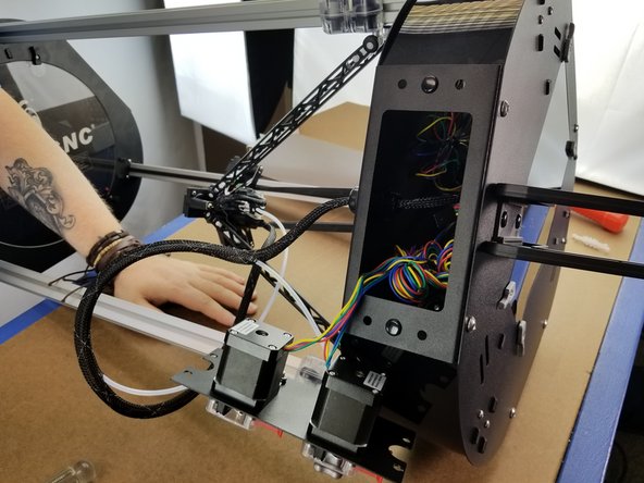 Pass the motor plug and wires through the opening in the extruder panel on your machine