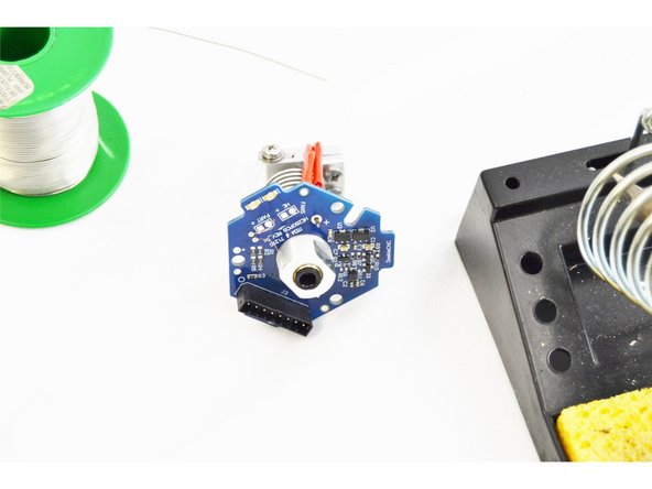 In photo #1 the heater cartridge lead is on the left (indicated by the + on the HE280 Hotend PCB board) and the thermal safety fuse is on the right. (noted with blue arrows)