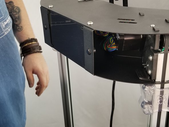 Insert the acrylic from the rear side of the upper frame.  Slide the acrylic behind the large opening and it will hold into place on its own when it is placed correctly.