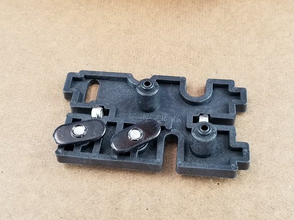 Using the small bracket and 2 idler pulleys, place the idlers on the pegs of the bracket as shown in Pic 2.