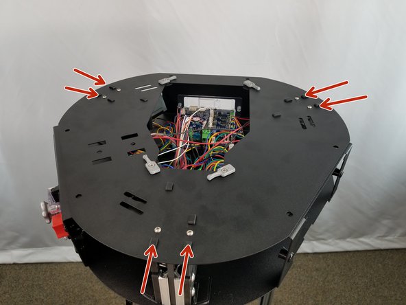 Tighten all 6 screws securely to attach the top plate to the motor mount brackets.