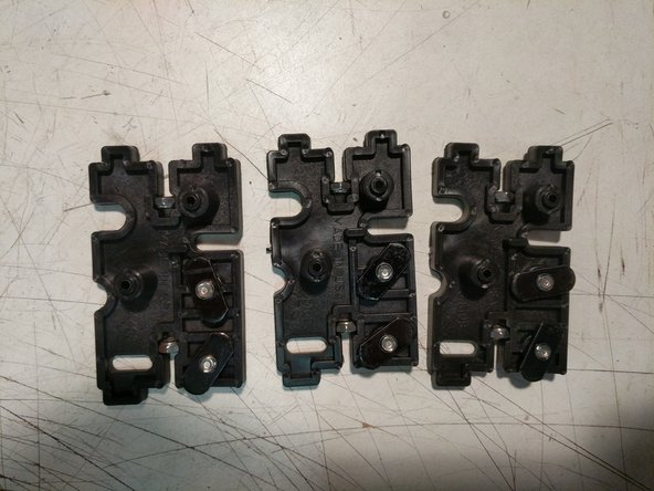 Insert the 6-32 nylon lock nuts into their pockets. (2 per injection molded piece).