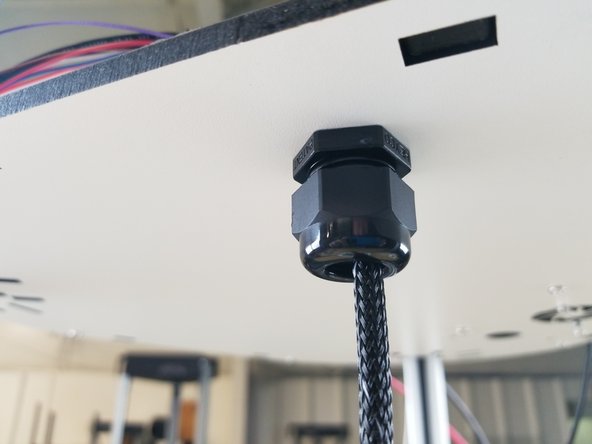 After installation, you will feed the hot end whip  (end without connectors) up from the bottom through the  strain relief.  Do not tighten at this time.