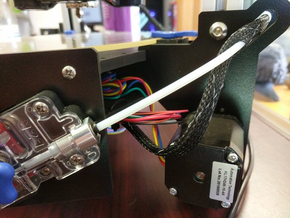 The Bowden tube is carried inside the mesh loom that holds the hot end wiring.