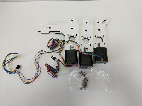 Locate the pieces shown in the image. You will have (3) laser cut parts labeled &quot;Stepper Motor&quot;, (3) Stepper Motors, and a back of M3 x10mm machine screws &amp; #4 Washers.