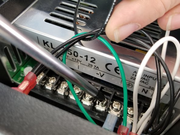 You will secure the ring terminal from the black wire to the next open spot of the power supply below the area labeled -V.