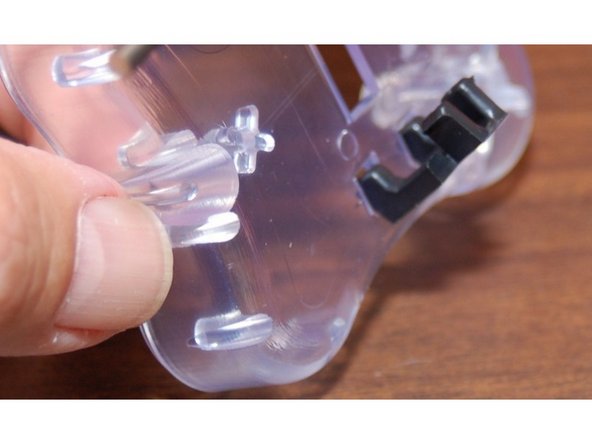 The third image shows how the belt clip fits into the holes on the carriage, but you'll be installing the top one first.