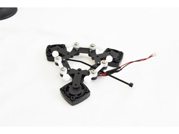 Install a wire tie to secure the leads you just worked on to the ball joint. The wire tie will route through the channel in the ball joint platform as shown in the picture.