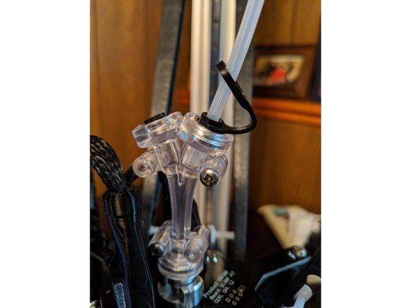 Using a razor blade or hobby knife, cut the PTFE tube in half making the cut as straight as possible to make the tube ends right angles.