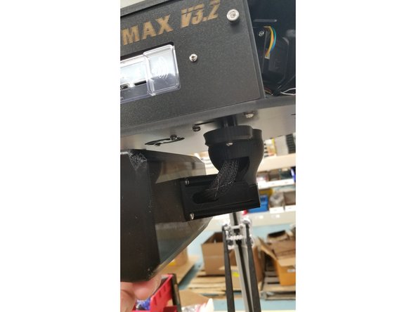 Pass the 6-32 x 1" machine screws through the touch screen arm assembly and the holes next to the Duet board as shown, and secure the screen assembly in place with the 6-32 nylon lock nuts.