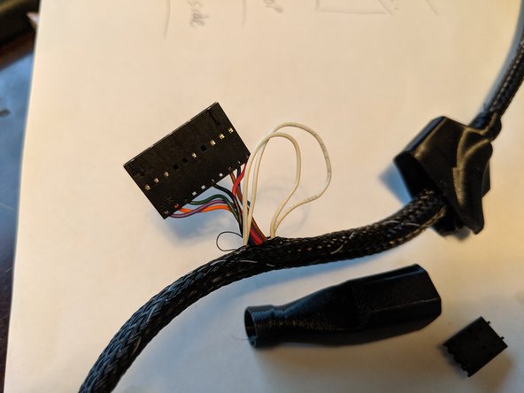 Using something like needle nose pliers, you will reach into the loom in the gap where all the wires for the 10 pin plug come out and grab the white wires and start to slide them out as shown in Pic 2.