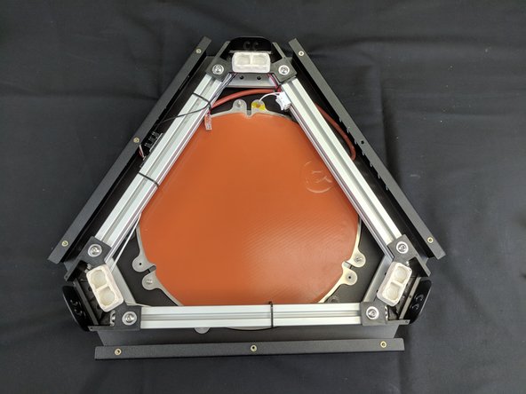 The base assembly is now ready to be installed. To do so we will need to carefully flip the machine over and set it on the floor. It is recommended to have something on the floor to protect it (carpet, cardboard, towel, etc) from getting scratches.