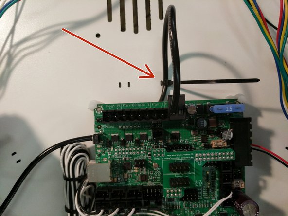 Locate a 2 position terminal block from the RAMBo kit. You will install the 12awg wire into that connector in the position indicated in the image. This is the negative position on the RAMBo board.