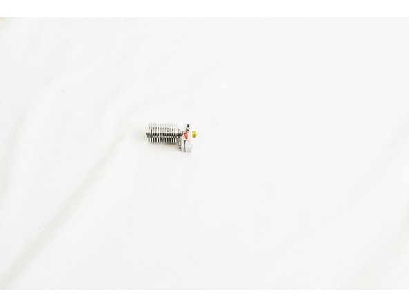 Screw the nozzle into the bottom of the heater block until it makes contact with the heat break. Finger tight!