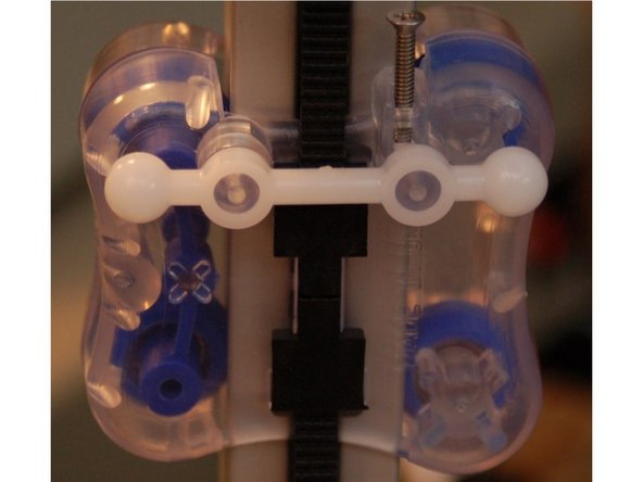 Press a Ball Arm on to the two mounting posts on the front of the carriage as shown in the first photograph.