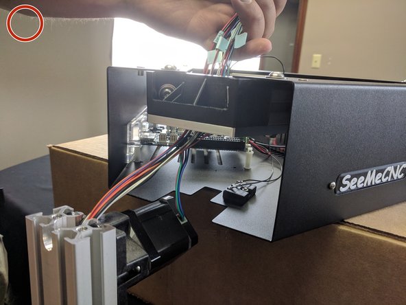 You will want to grasp all the wires that are exiting the top of the X tower and push the bundle down in the relief that is cut into the T-Slot. Pushing down on the wires will help create a little memory in the wiring.