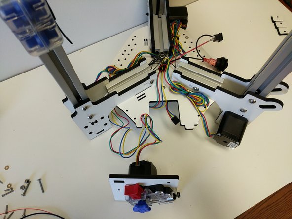 Set the EZR Struder on the work surface with the printer. Route the stepper motor wire down through the hole in the center of the base assembly base plate and plug it into the Mini-RAMBo. Plug into the connecter closest to the fuses. Make sure the red wire on the connecter is positioned​ closest to the fuse.