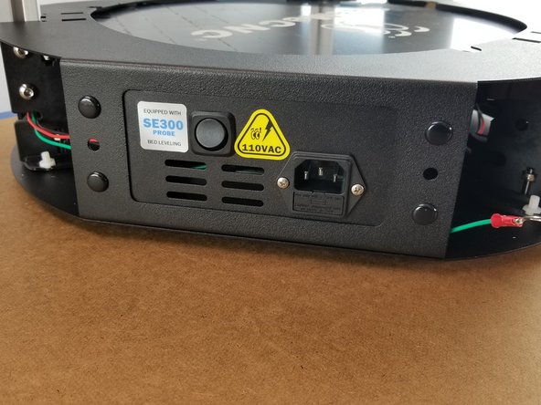 Press the rivet head to lock the cover plate to the power supply bracket.