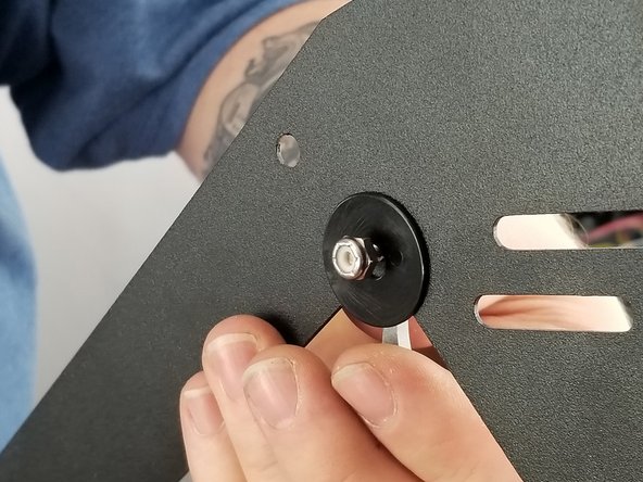 Insert the screws through the build plate clamps and into the sheet metal.