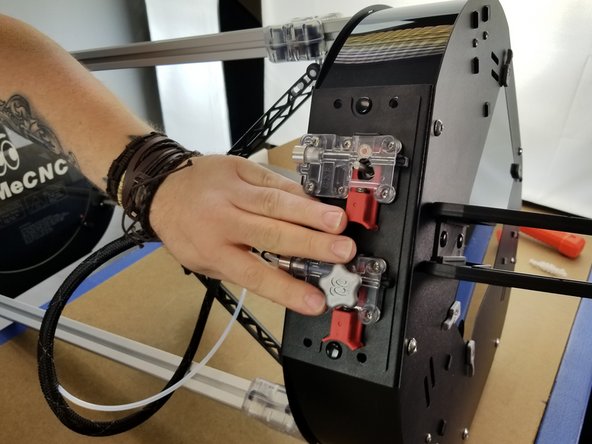 Place the extruder panel back where it belongs on your machine.